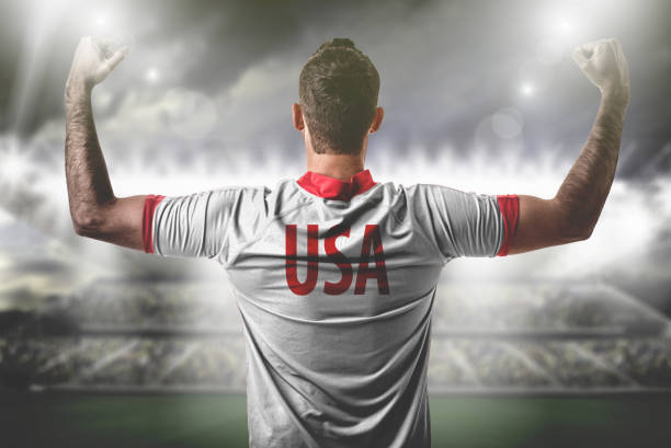 istock American Fan / Sport Player on uniform celebrating 697122248