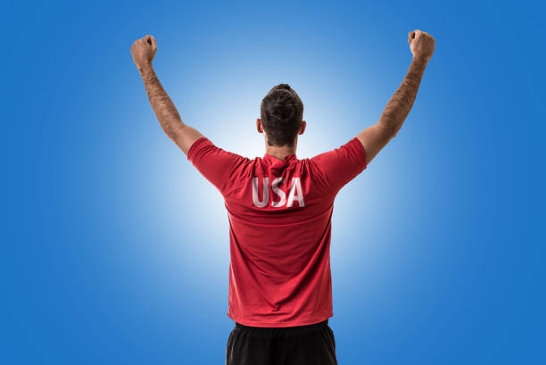 istock American Fan / Sport Player on uniform celebrating 697122272