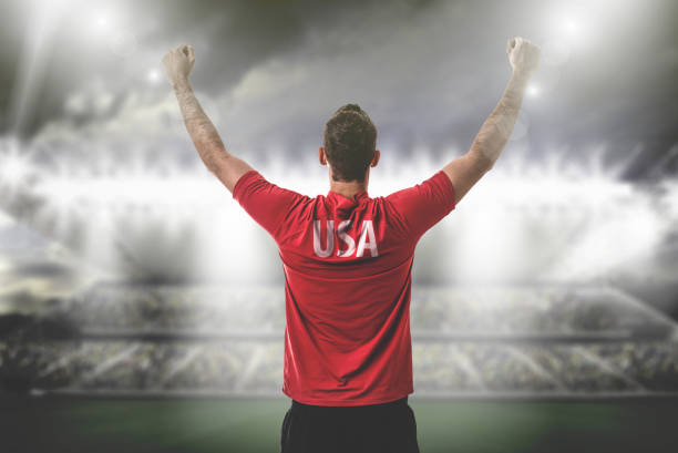 istock American Fan / Sport Player on uniform celebrating 697122280