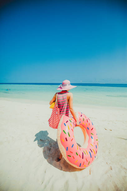 istock Hipster woman standing on beach, Maldives 697122600