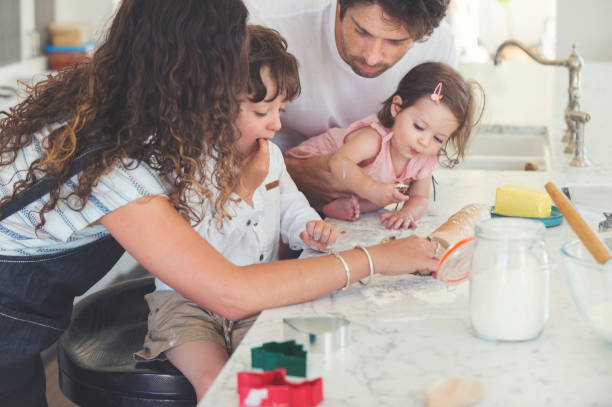 istock Family enjoying making cookies together. 697123120