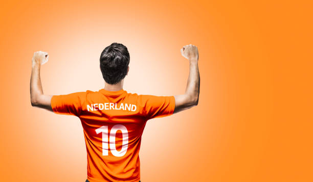 dutch fan / sport player on uniform celebrating - holanda futebol imagens e fotografias de stock