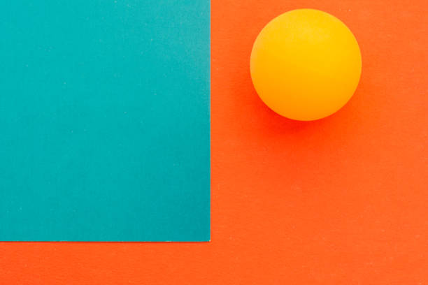 istock yellow tennis ball on a red blue background 697127786