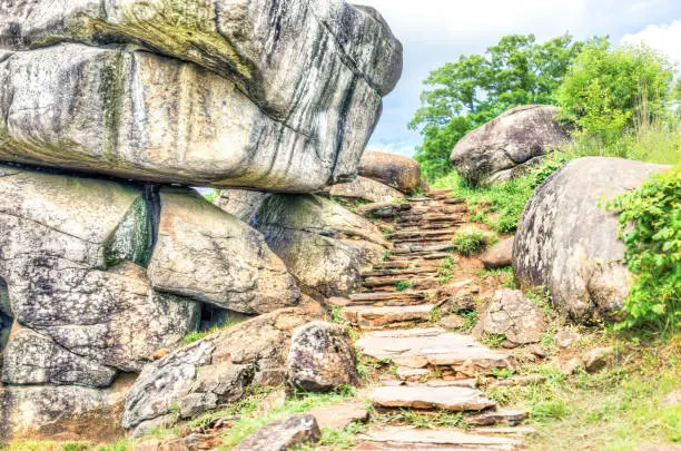 Photo of Trail leading to Devil's Den in Gettysburg battlefield national park with rock boulders during summer