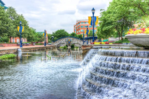 Carroll Creek in Maryland city park with canal, bridge and fountain waterfall and flowers in summer Frederick: Carroll Creek in Maryland city park with canal, bridge and fountain waterfall and flowers in summer 1354 stock pictures, royalty-free photos & images