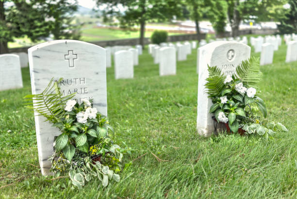 Gettysburg National Cemetery battlefield park with closeup of two grave stones and flowers Gettysburg National Cemetery battlefield park with closeup of two grave stones and flowers gettysburg national cemetery stock pictures, royalty-free photos & images