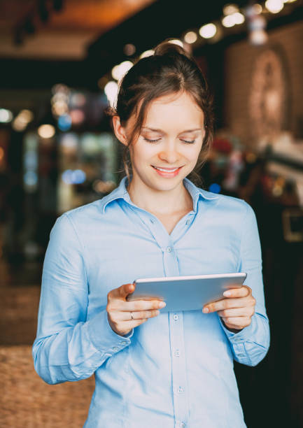 istock Smiling young woman using modern gadget_tone 697134424