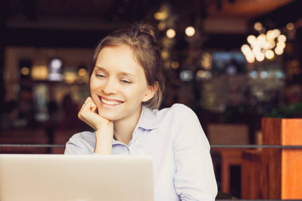 istock Pleased business lady looking at laptop screen_tone 697134426
