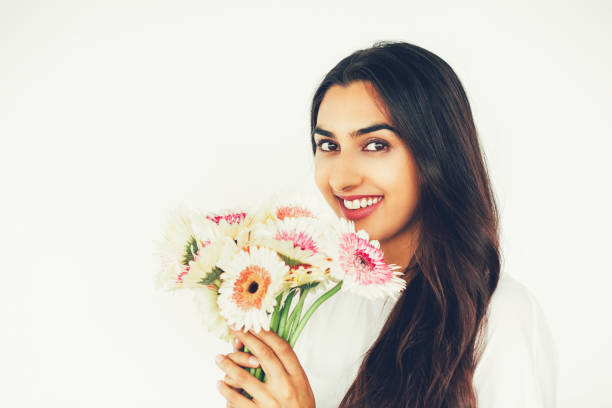 istock Smiling Nice Indian Lady Holding Bunch of Flowers 697134530