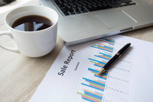 istock background business stuff, laptop, coffee, pen, graph ,on wooden desk 697141586