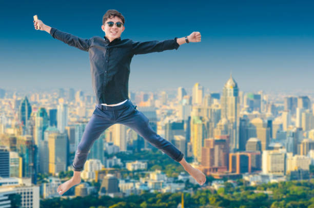 istock Young business man using laptop and digital tablet cityscape background 697143756