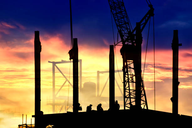 istock Silhouette tower cranes build large residential buildings  at construction site 697144186