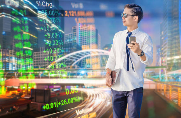 istock Young business man using laptop and digital tablet cityscape background 697144492