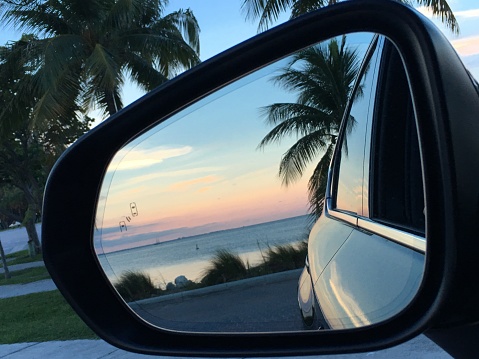 Reflection Of A Beautiful Sunset In Side View Mirror Of Car