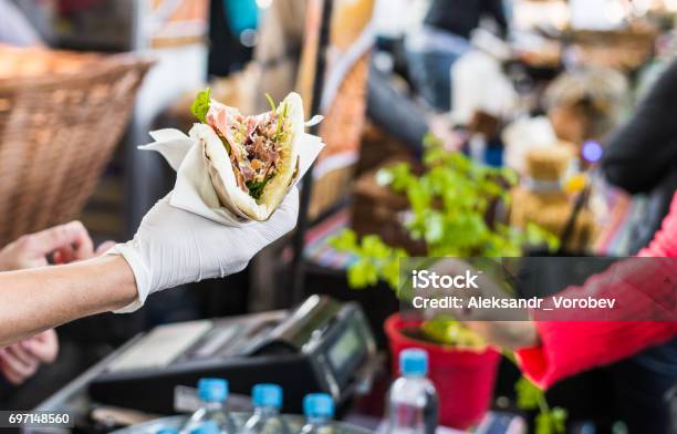 Chef Handing A Tortilla To A Foodie At A Street Food Market Stock Photo - Download Image Now