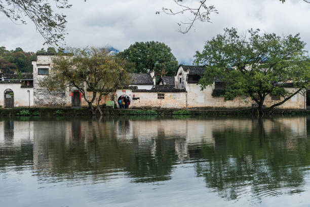 istock Chinese traditional architecture surrounded by the lake against sky 697151184