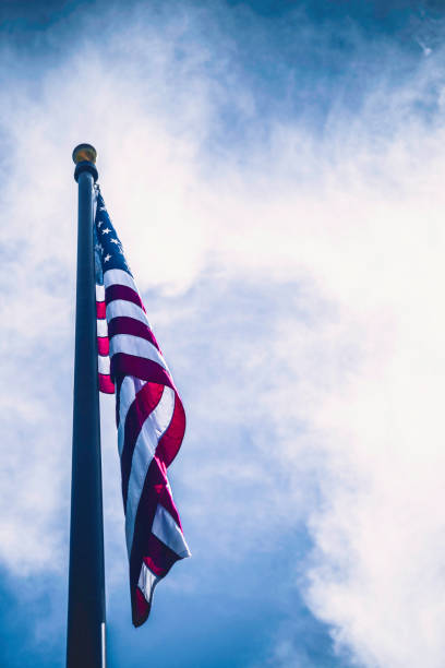 istock American flag against blue summer sky 697156184