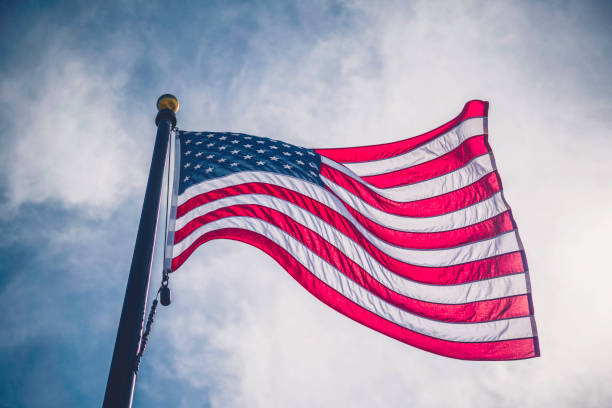 american flag against blue summer sky - american flag flag usa sky imagens e fotografias de stock