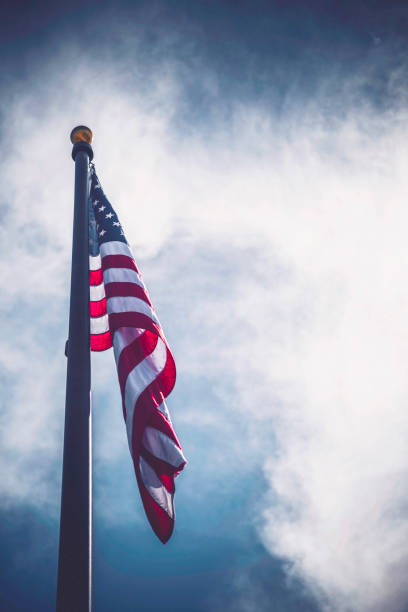 istock American flag against blue summer sky 697156214