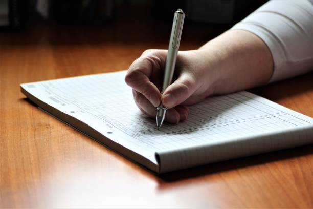 istock An Image of a Hand with pen - writing 697173000
