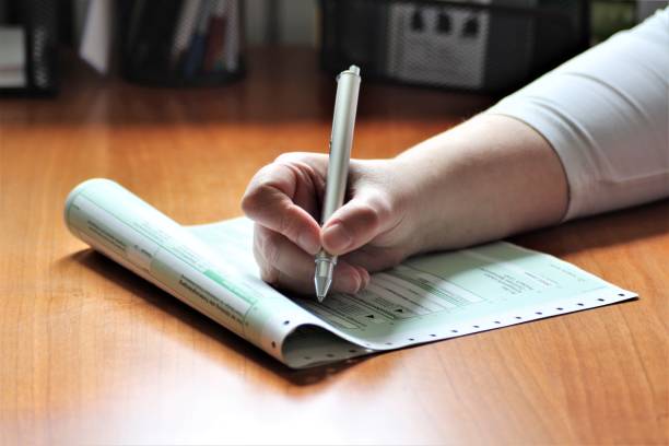 istock An Image of a Hand with pen - writing 697173006