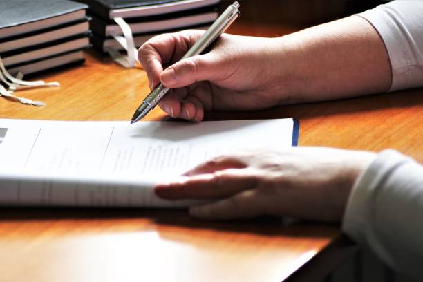 istock An Image of a Hand with pen - writing 697173056