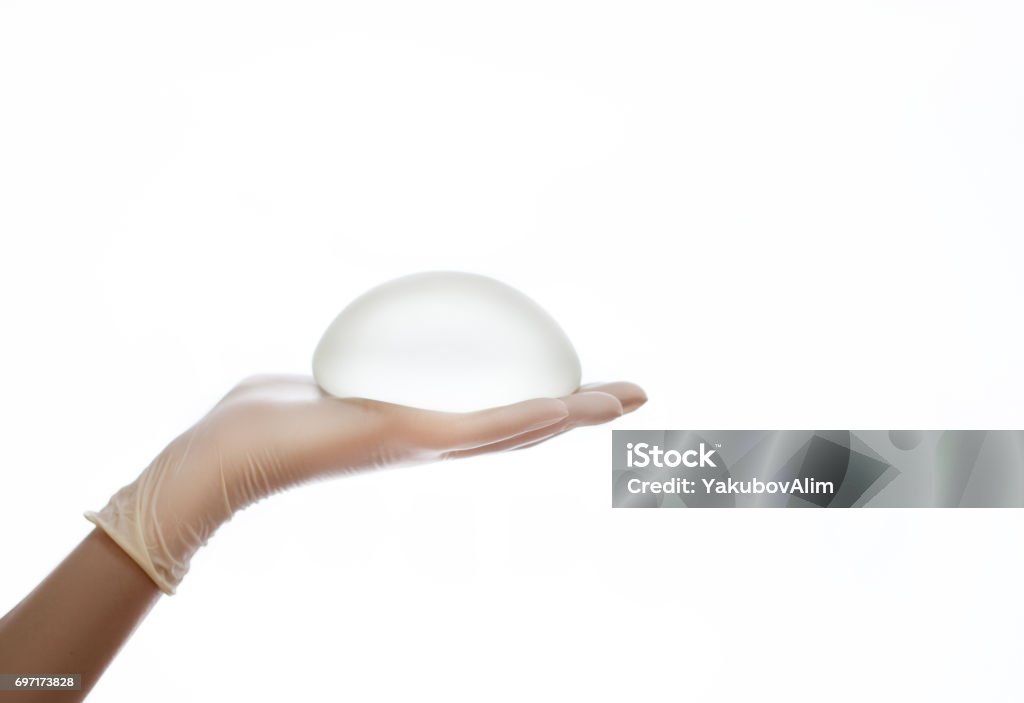 Silicone breast implant on hands Breast Implant Stock Photo