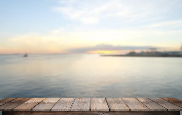 istock Empty Top of wood table with blurred Twilight sea background 697176942