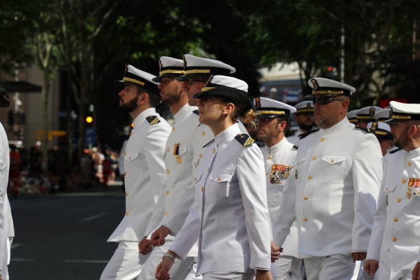 Australian Navy officers marching BRISBANE, AUSTRALIA - APRIL 25, 2017: Australian Royal Navy members march in the ANZAC parade. australian navy stock pictures, royalty-free photos & images