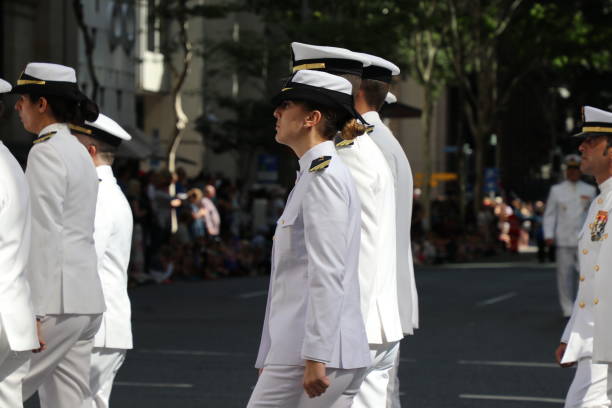 Australian Navy officers marching BRISBANE, AUSTRALIA - APRIL 25, 2017: Australian Royal Navy members march in the ANZAC parade. australian navy stock pictures, royalty-free photos & images