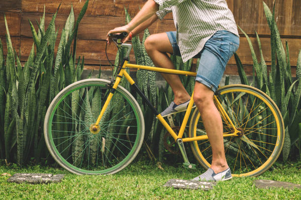 istock Young attractive man enjoying outdoors with old bicycle. 697194236