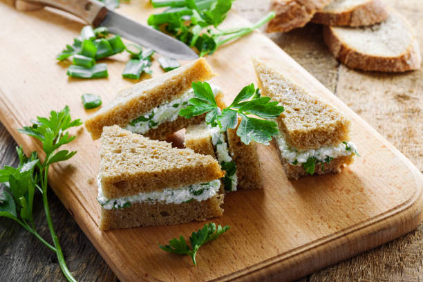 istock Cream cheese sandwiches with parsley and green onion 697201232