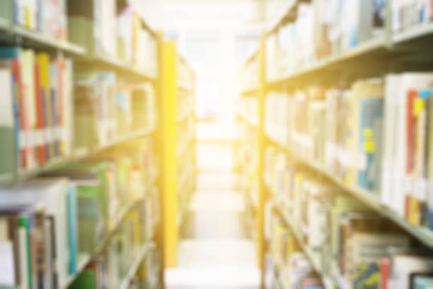istock Books on bookshelf in library room, abstract blur de focused background 697211538