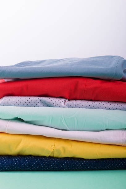 istock Stack of bright female trousers. Folded colorful pants and jeans.  Close up 697217806