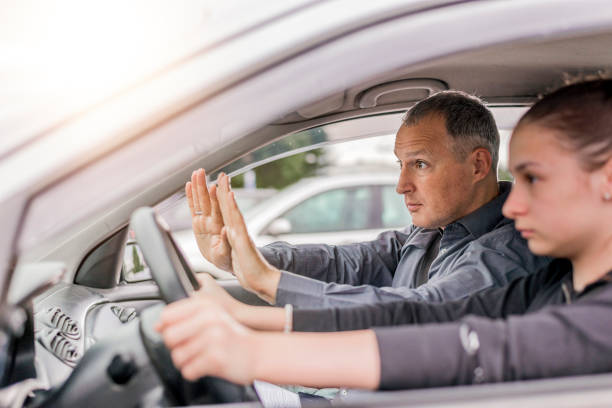 istock Angry aggressive teen driving car with instructor 697218720