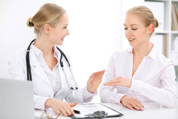 istock Doctor and  patient  sitting at the desk 697224518