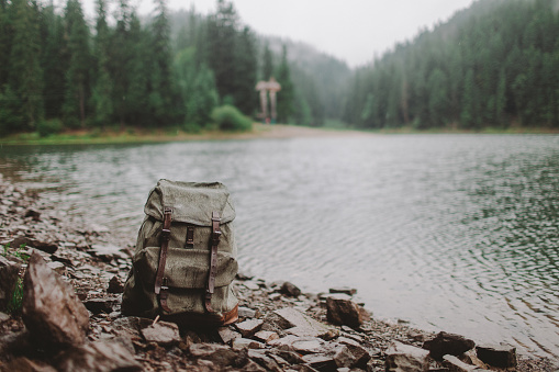 Old fashioned backpack near the lake in mountains, Ukraine