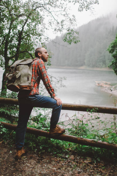 istock Man hiking near the forest in mountains 697228318