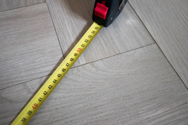 istock Tape measure yellow and black on ground 697231662
