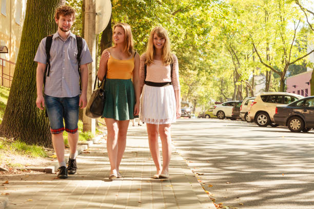 istock Three people friends walking outdoor. 697234712