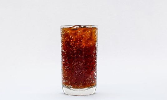 Frosty mug of root beer with ice on white