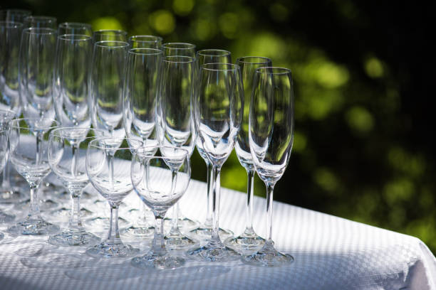 empty glasses arranged on a table in the restaurant, cafe, or bar. preparation for the birthday, wedding, or any celebration day. - bentham imagens e fotografias de stock