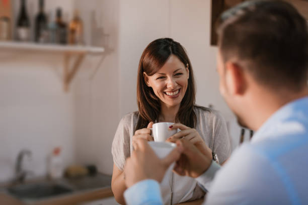 istock Cute young couple drinking coffee in kitchen. 697235220