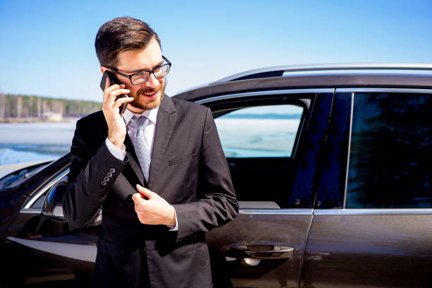 istock Businessman on a cell phone near his car 697236108