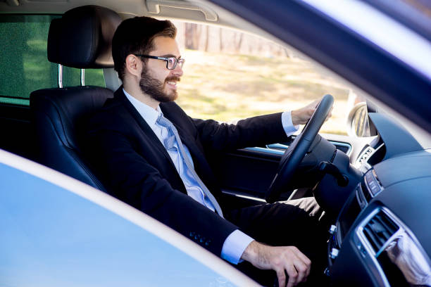 istock Businessman sitting in a car 697236412