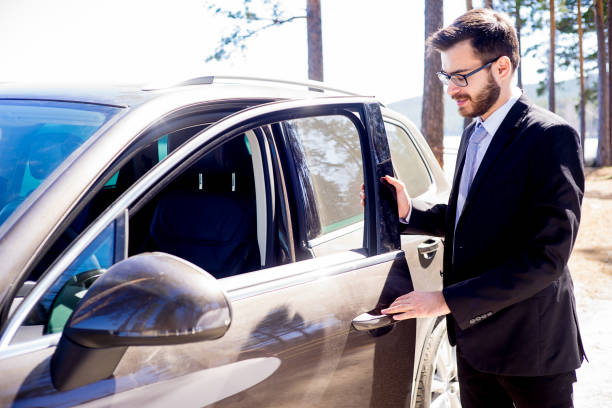istock Happy man entering his car 697239014