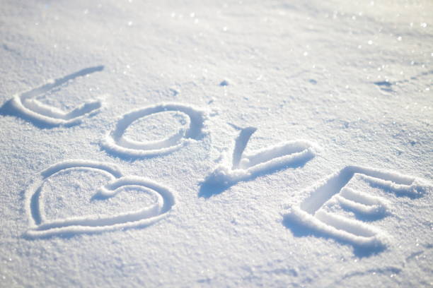 istock Word love written on the snow and heart 697239698