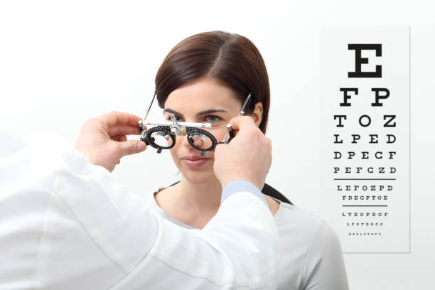 istock woman doing eyesight measurement with trial frame and visual test chart on white 697248484