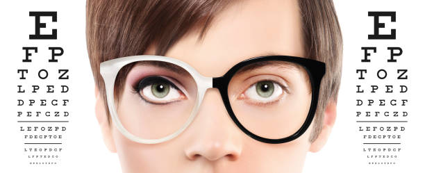 istock eyes and eyeglasses close up on visual test chart, eyesight and eye examination concept in white background 697248496