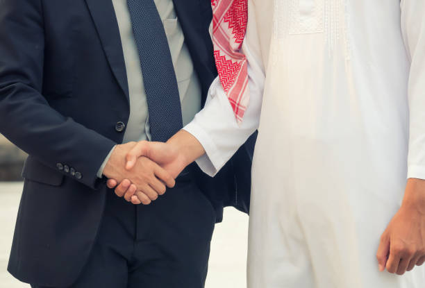 istock Businessman and Business Arabian man hands shaking 697252962
